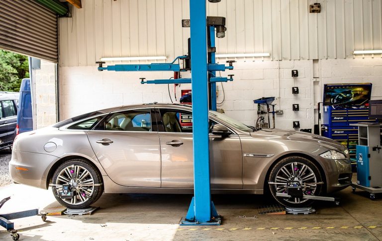 A vehicle receiving a 4-wheel alignment service at Phipps Motors