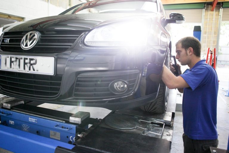 Our Services - Servicing A vehicle technicial working on the wheel of a car at Phipps Motors