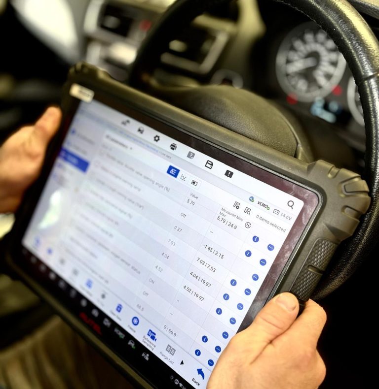 A vehicle technician using Phipps Motors' advanced diagnostic tools