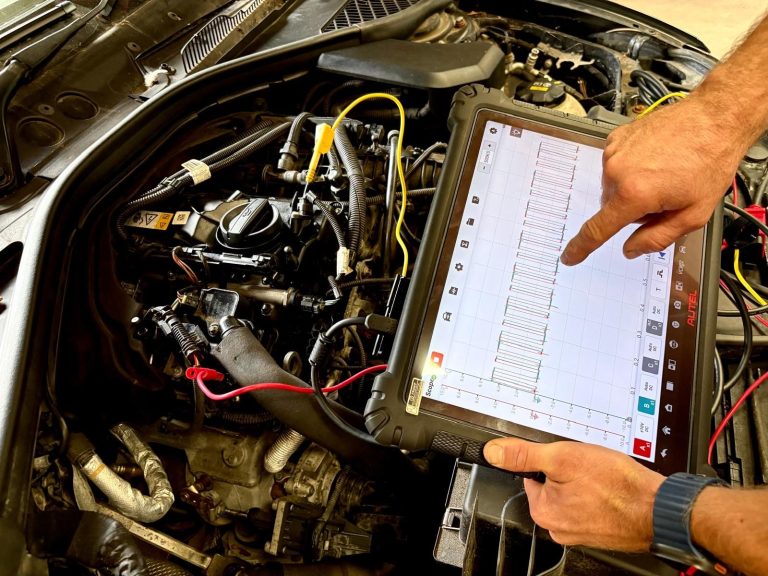 A vehicle technician using Phipps Motors' advanced diagnostics tools