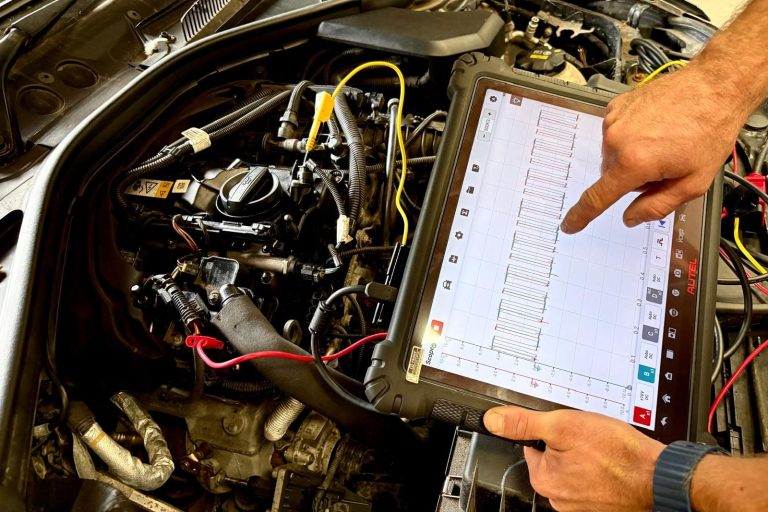 Our Services - Diagnostics A vehicle technician using Phipps Motors' advanced diagnostic tools
