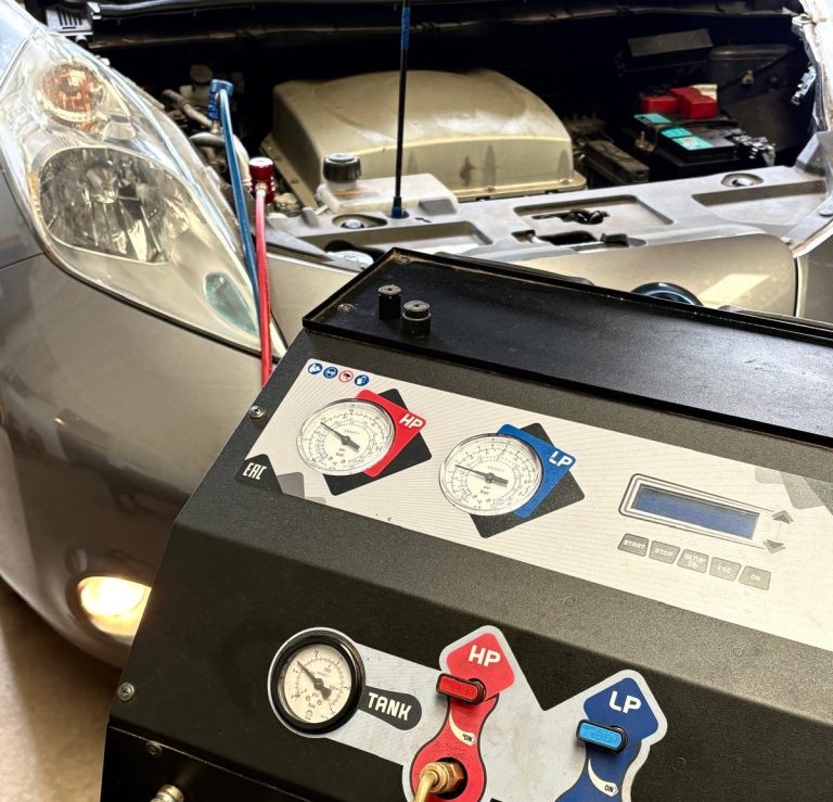 A vehicle receiving an air conditioning service with specialist equipment at Phipps Motors